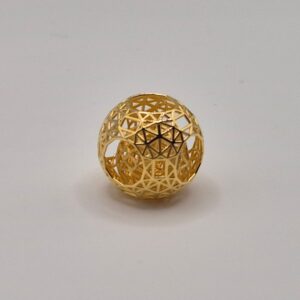 Showcase of a gold cast geometric sphere in 18 carat yellow gold.
