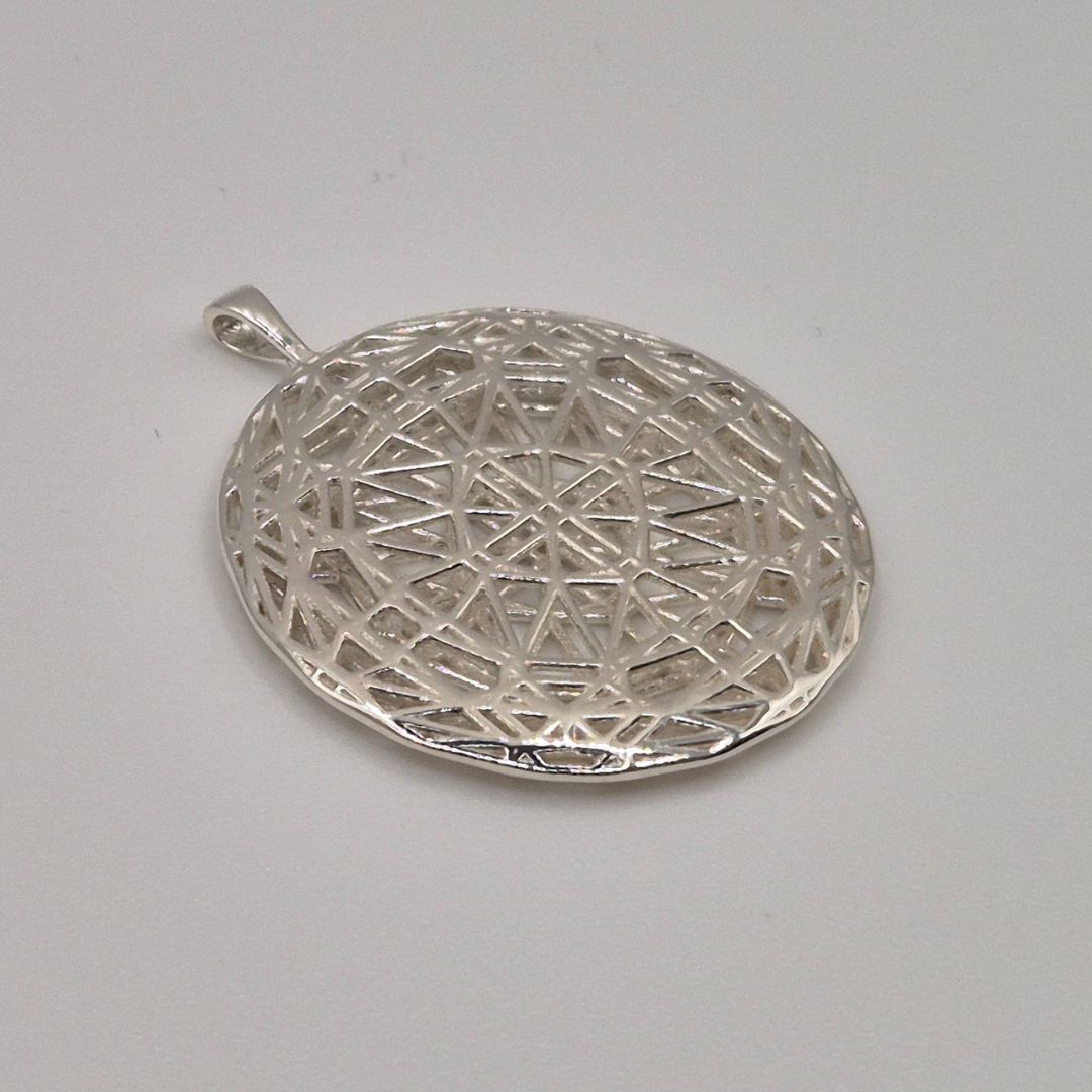 Intricate cast silver pendant with geometric lattice design