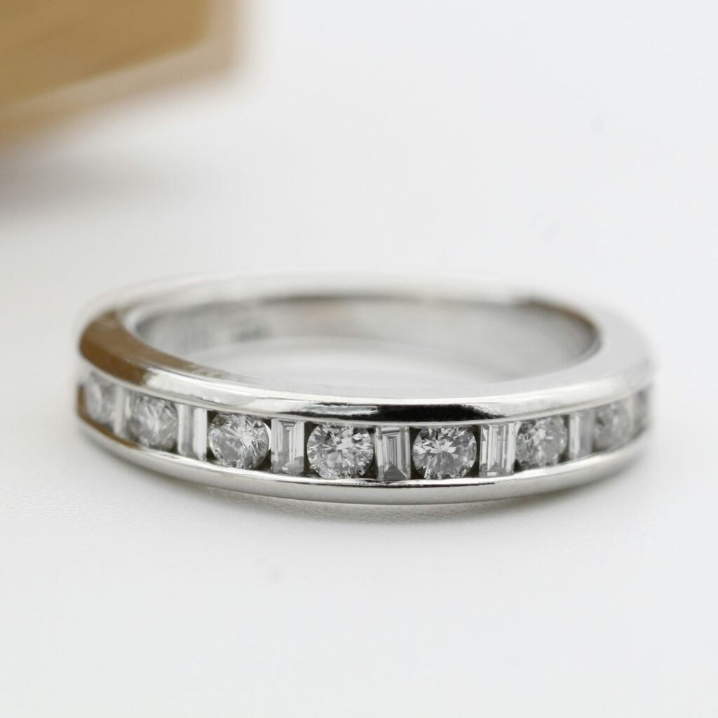 Channel-set platinum ring featuring a row of brilliant-cut diamonds, showcasing the sleek, durable elegance of platinum.