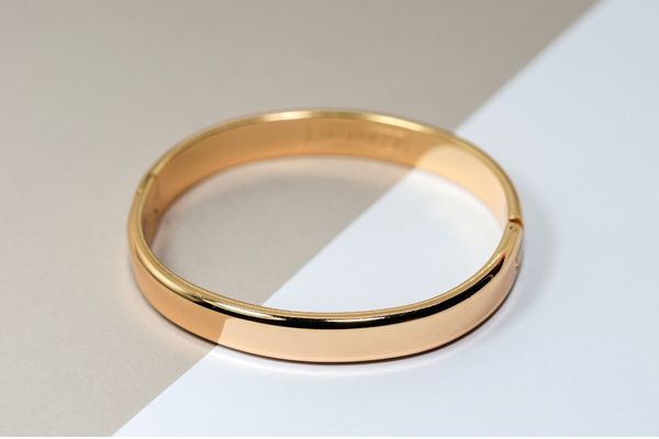 Solid gold bangle bracelet with a high-polish finish, cast in yellow gold.