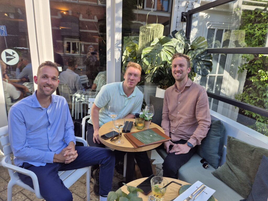 A photo of the c-founders of Castimize (Oscar, Robin and Koen) sitting outside together.