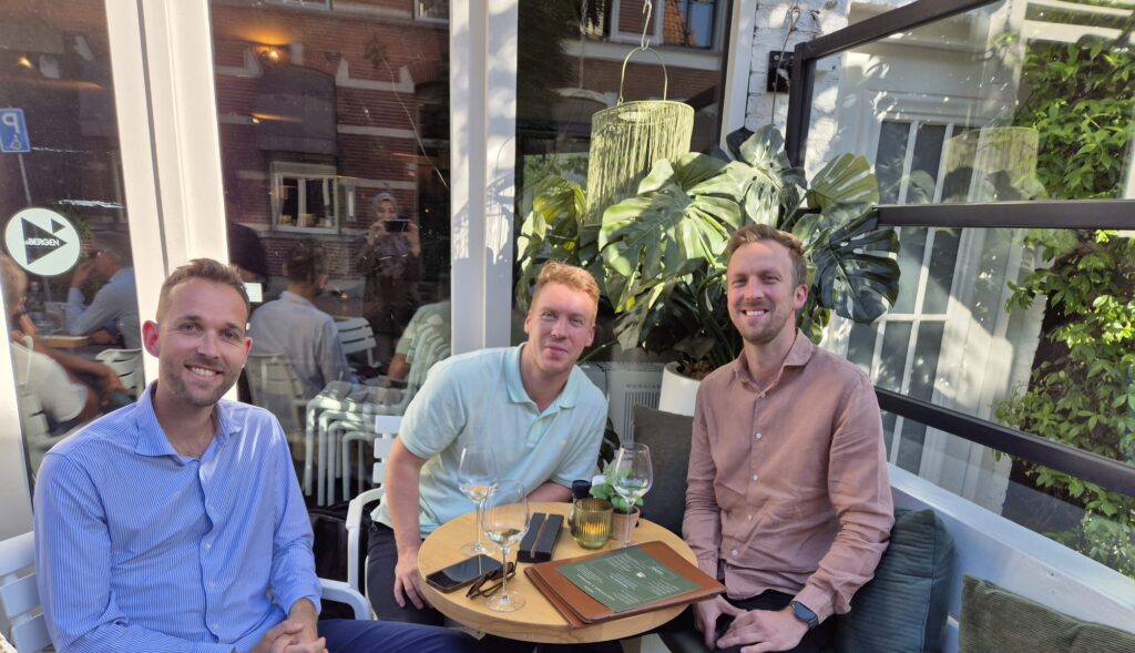 A photo of the c-founders of Castimize (Oscar, Robin and Koen) sitting outside together.